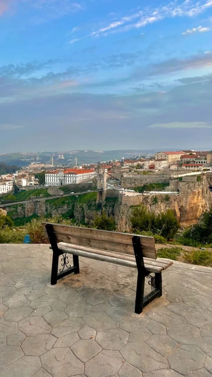 A bench on a terrace looking out over the Sidi M’Cid bridge and Constantine