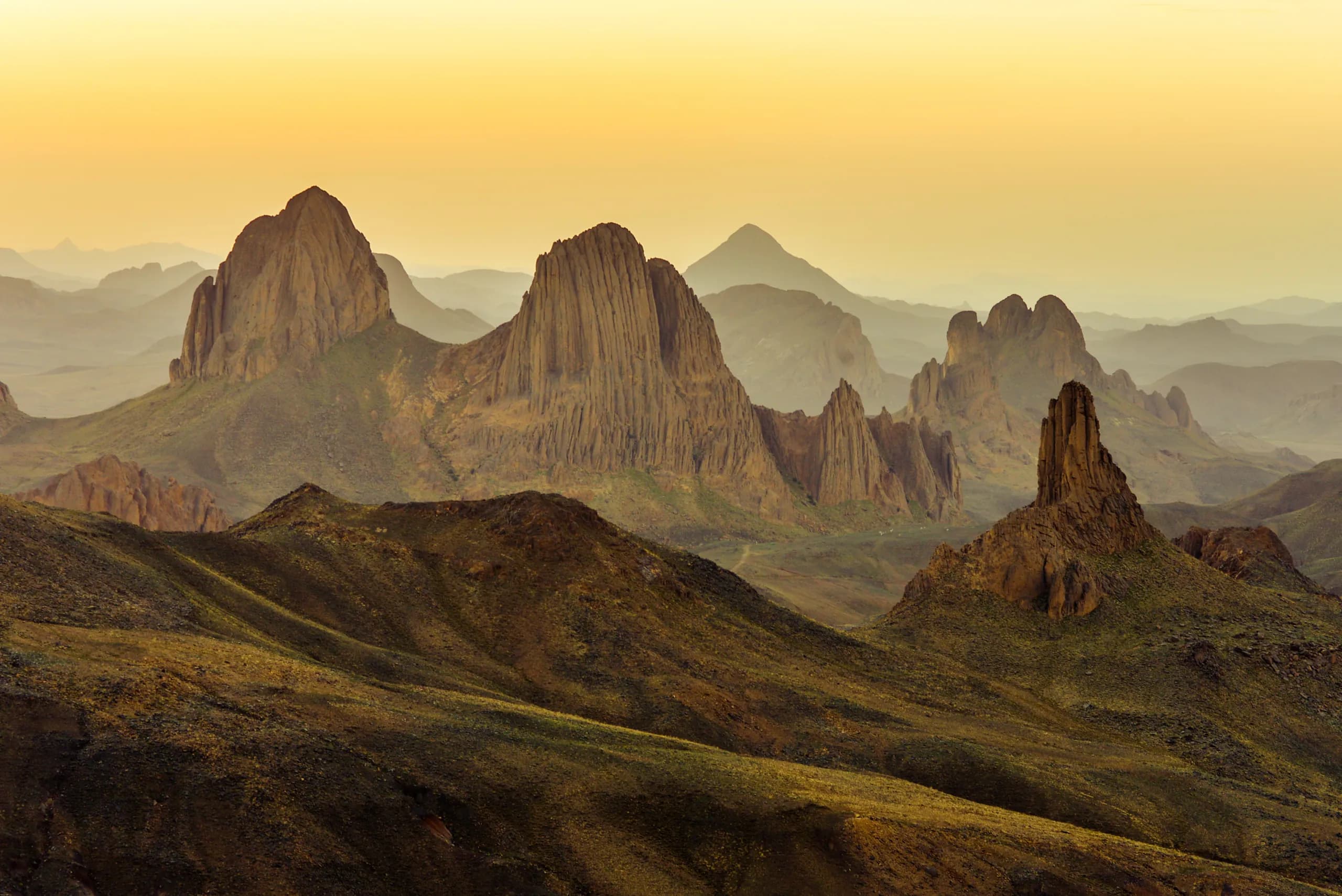 Volcanic peaks of the Hoggar rising out of the haze at Assekrem, near Tamanrasset